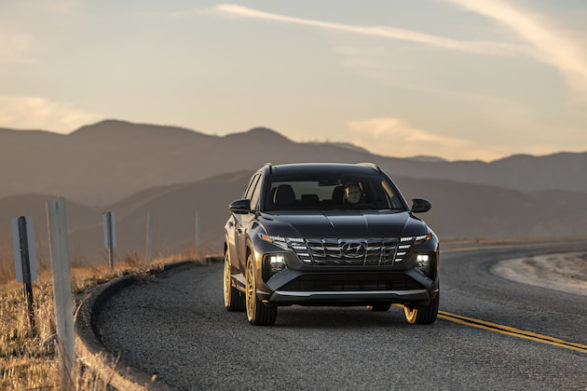 a dark slate colored hyundai tucson driving through the desert