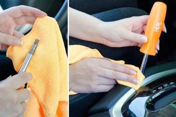 a cloth wrapped around the tip of a screwdriver to clean small places in a car