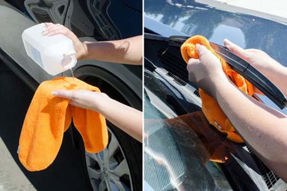 rubbing alcohol being poured onto a towel used to clean a window wiper