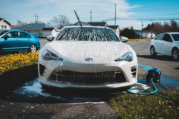 a car covered in soap in the process of being washed