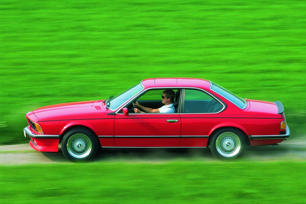 a person driving a red car