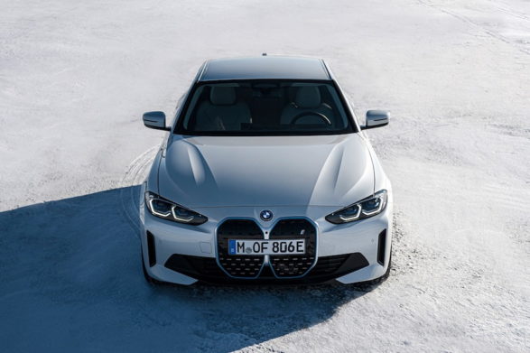 a white bmw i4 photographed on a salt flat