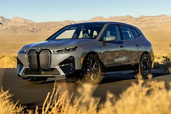 a bmw ix driving along a road