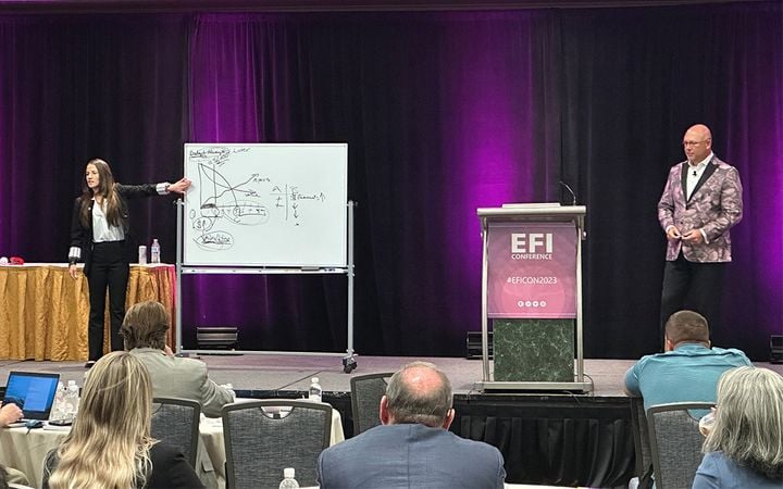 iA American Warranty Group’s Shelly Ligget and Tony Dupaquier share the stage at EFI Con 2023. - 2023 EFI Shelly Liggett Tony Dupaquier rgb