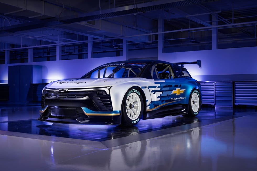 nascar race car prominently displayed in a garage environment